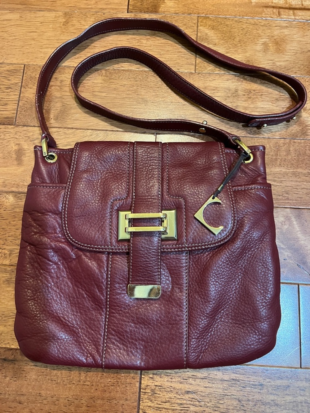 Liz Claiborne red leather crossbody bag with gold hardware & signature charm